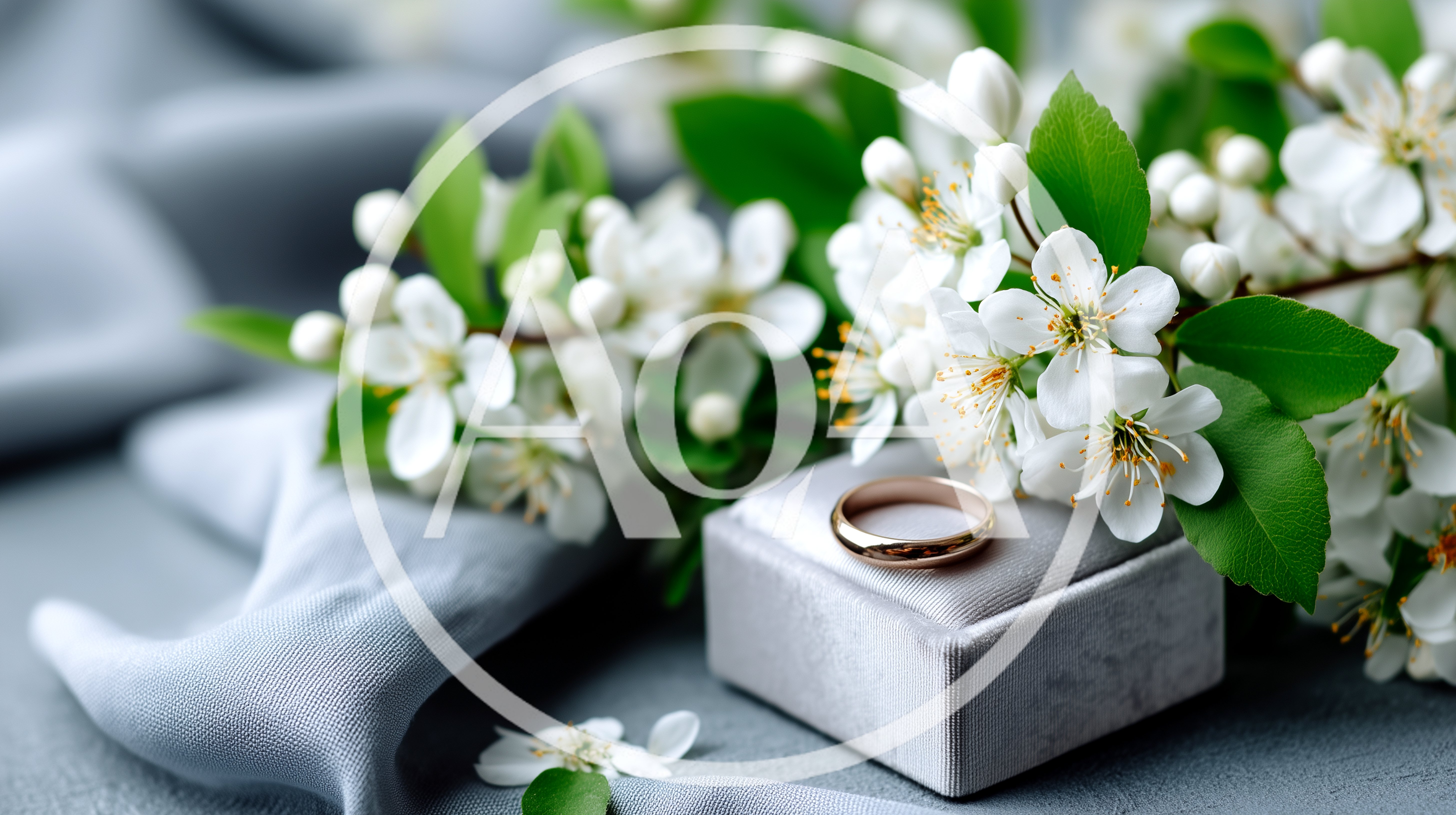 Gold Wedding Ring On Velvet Box With White Blossoms