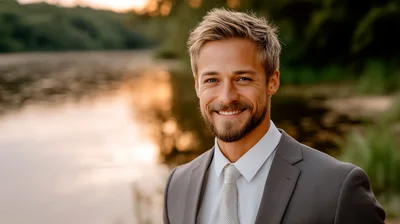 Handsome Man In Suit Smiling Outdoors At Sunset