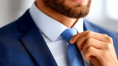 Businessman Adjusting His Blue Necktie In Professional Attire