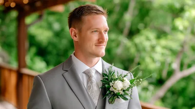 Groom Wearing Grey Suit With Floral Boutonniere