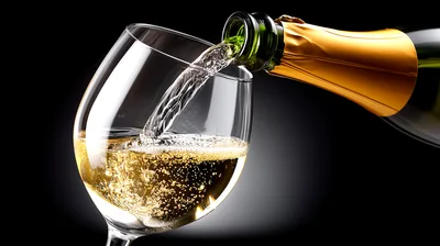 Champagne Being Poured Into A Crystal Wine Glass