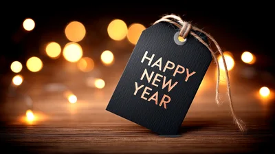 Happy New Year Text On Black Tag With Bokeh Lights