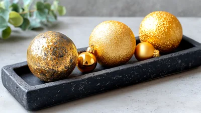 Gold Christmas Ornaments on a Black Concrete Tray