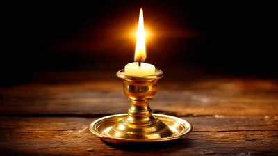 Lit Candle In A Vintage Brass Candlestick