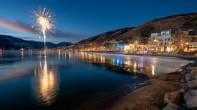 Fireworks Display Over A Frozen Lakefront Town