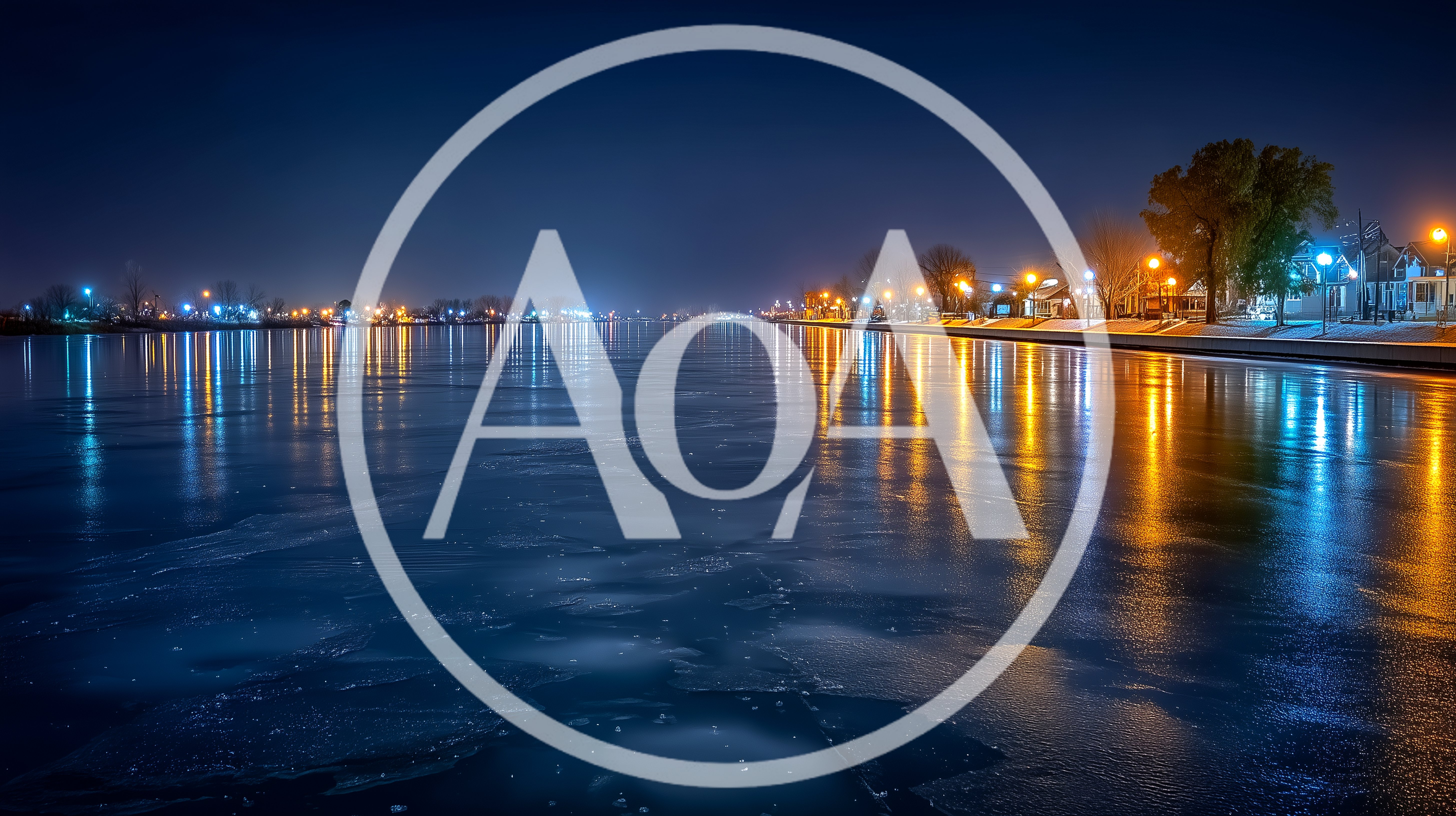 Nighttime View Of A Frozen River With City Lights