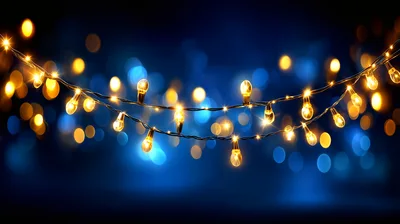 Glowing String Lights Against A Dark Blue Bokeh Background