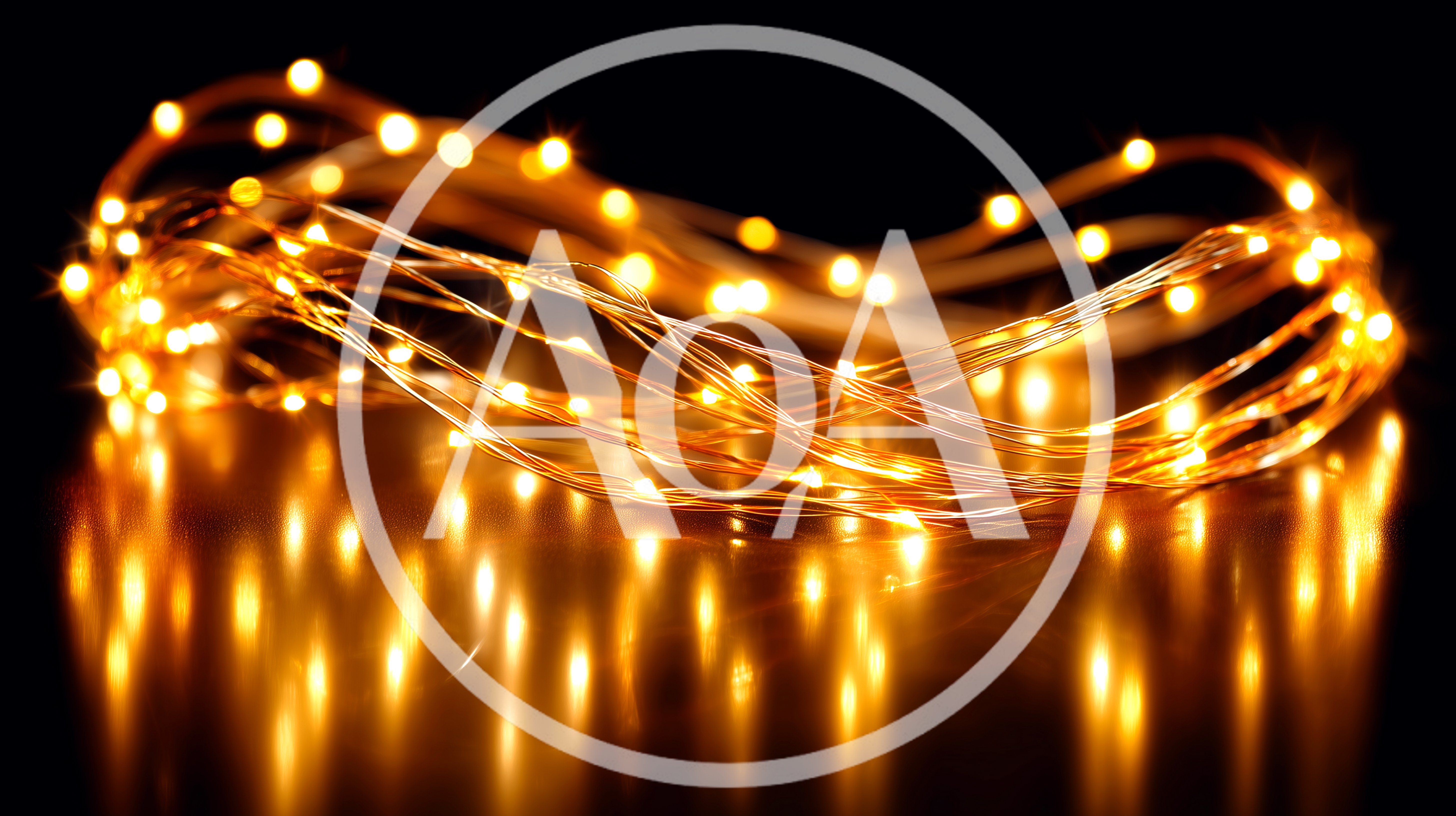 Glowing Warm Fairy Lights Coiled on Reflective Surface