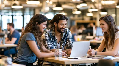 Diverse Students Collaborating on Laptop in Modern Office