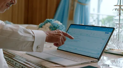 Businessman Pointing At Laptop Screen In Office