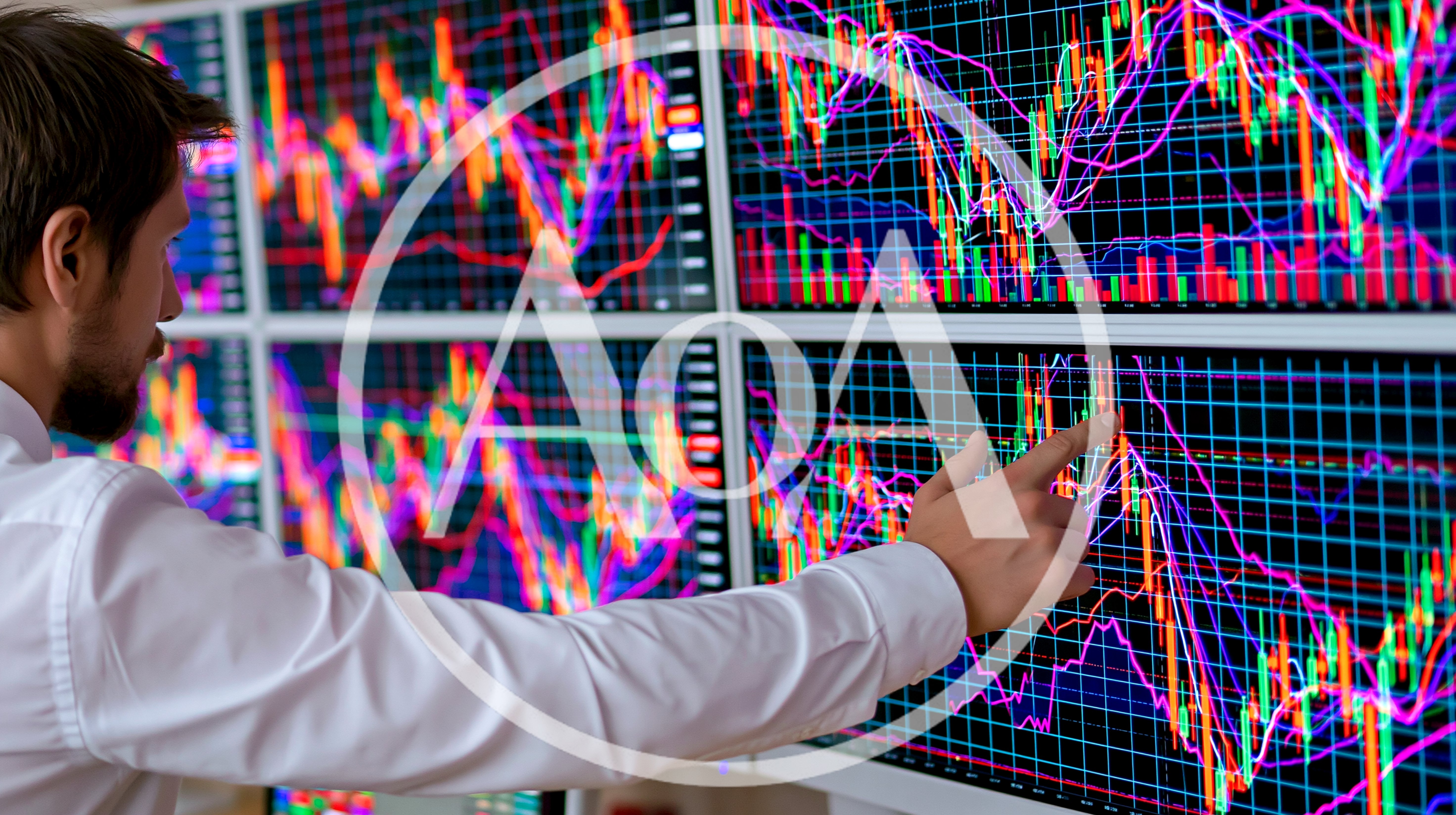 Financial Analyst Monitoring Stock Market Data On Multiple Screens