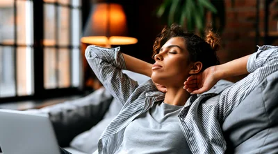 Young Woman Relaxing On Sofa With Laptop
