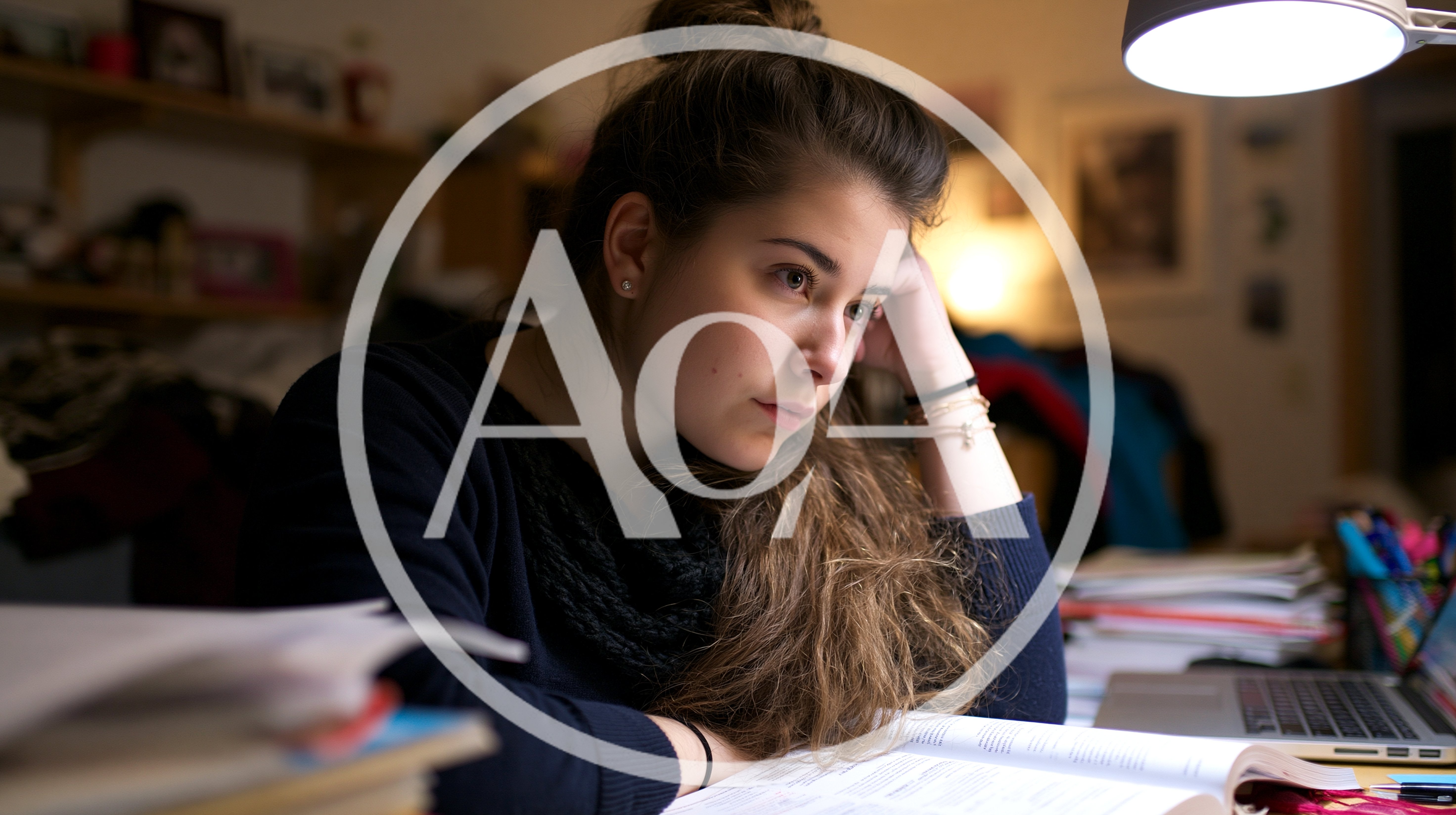 Young Woman Studying Late At Night Under Desk Lamp