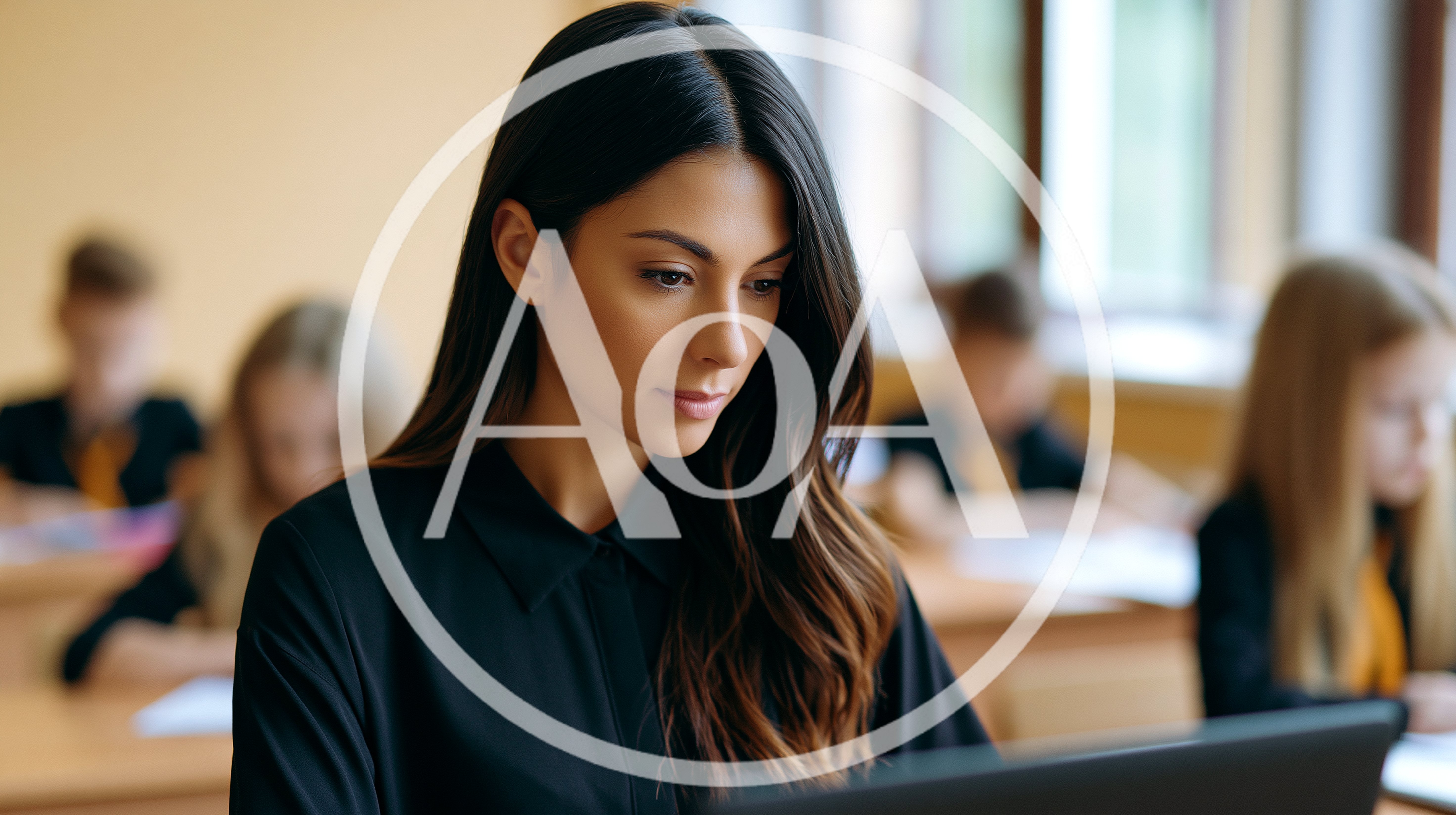 Female Teacher Working On Laptop In Classroom