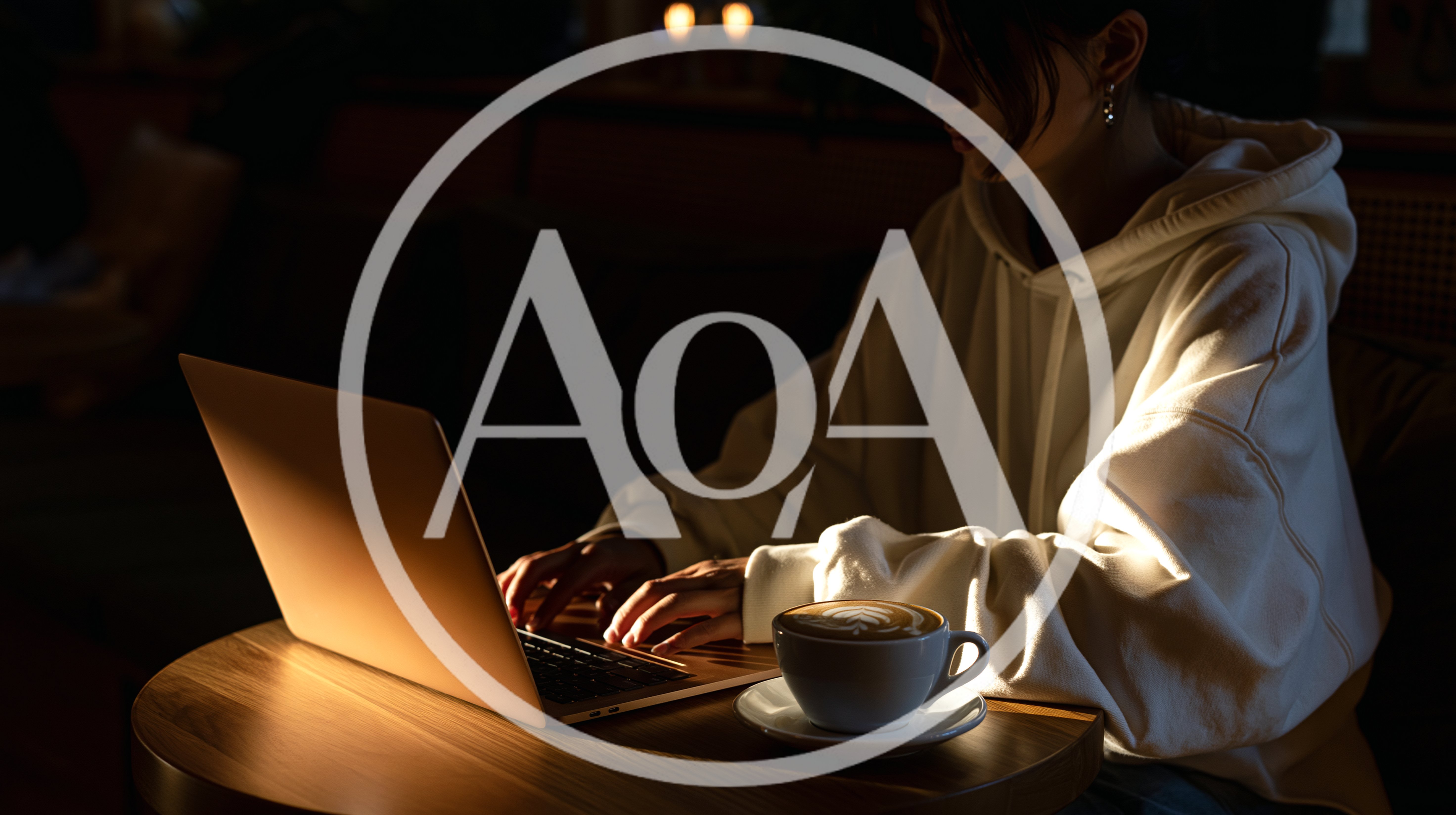 Young Woman Working on Laptop in Dimly Lit Cafe