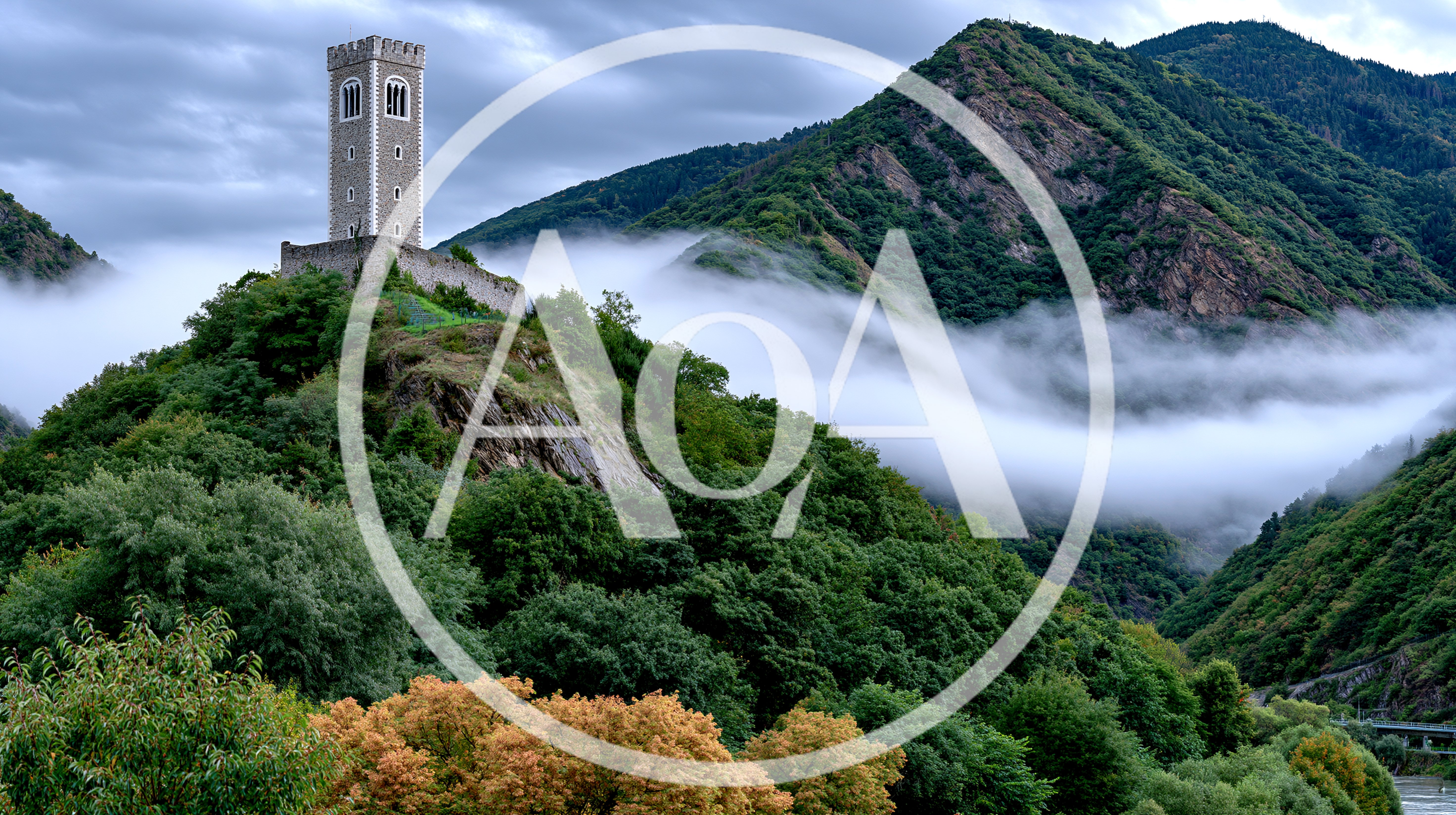 Medieval Stone Tower Atop A Lush Mountain Peak