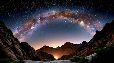 Milky Way Galaxy Arching Over Rugged Mountain Landscape