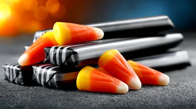 Candy Corn Pieces Resting On Wrapped Chocolate Bars