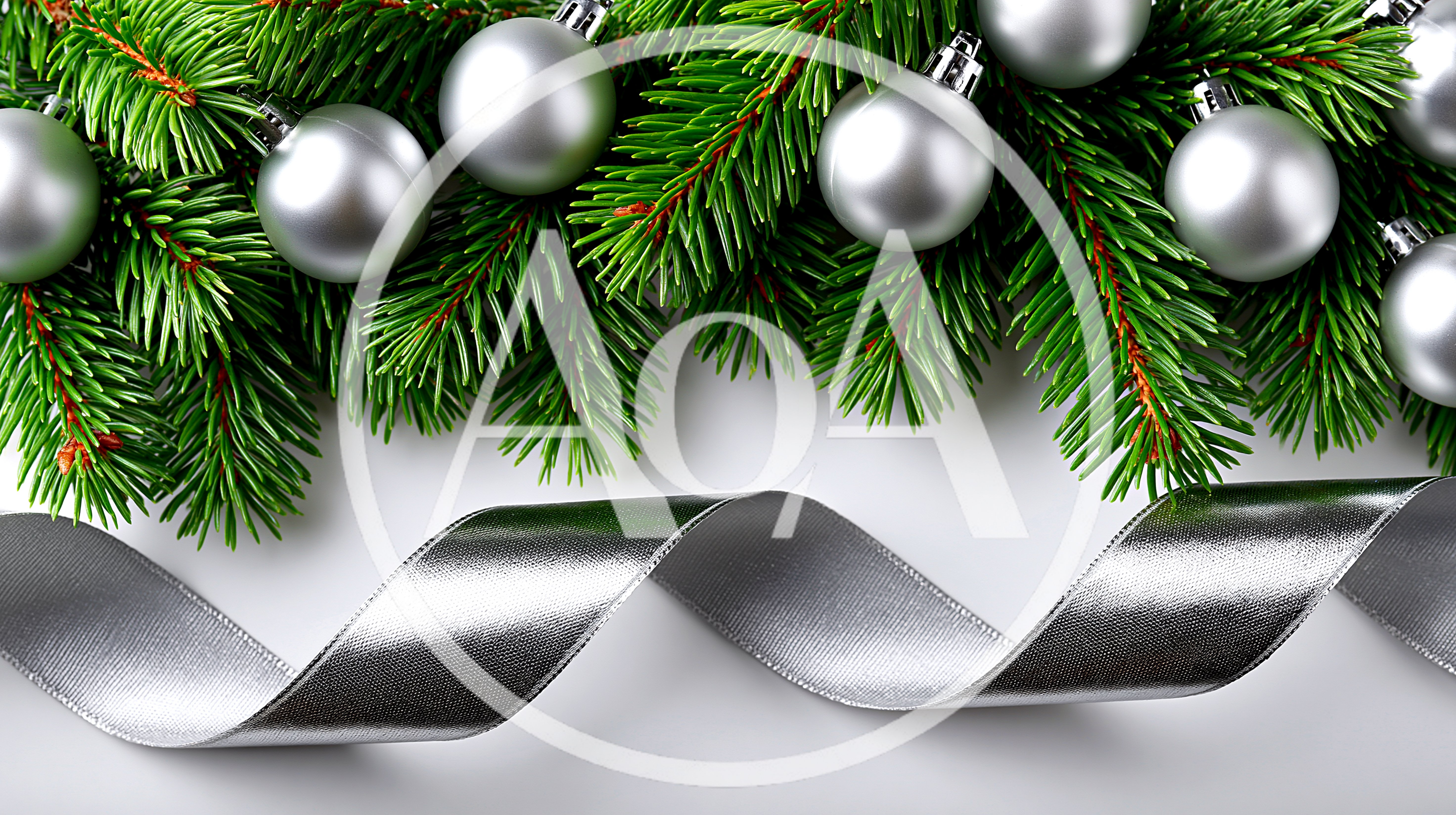 Silver Christmas Ornaments And Ribbon On Pine Branches