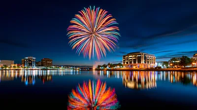 Colorful Fireworks Display Over A City Waterfront At Night