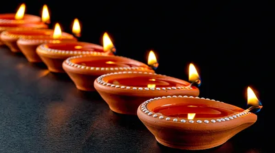 Row Of Lit Clay Diyas For Diwali Celebration