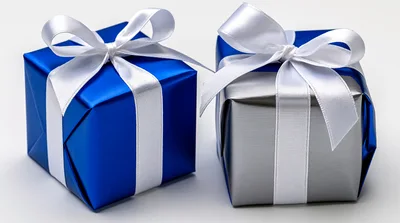 Two Wrapped Gift Boxes With White Ribbons