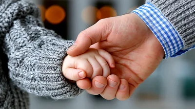 Adult Holding A Small Child Hand