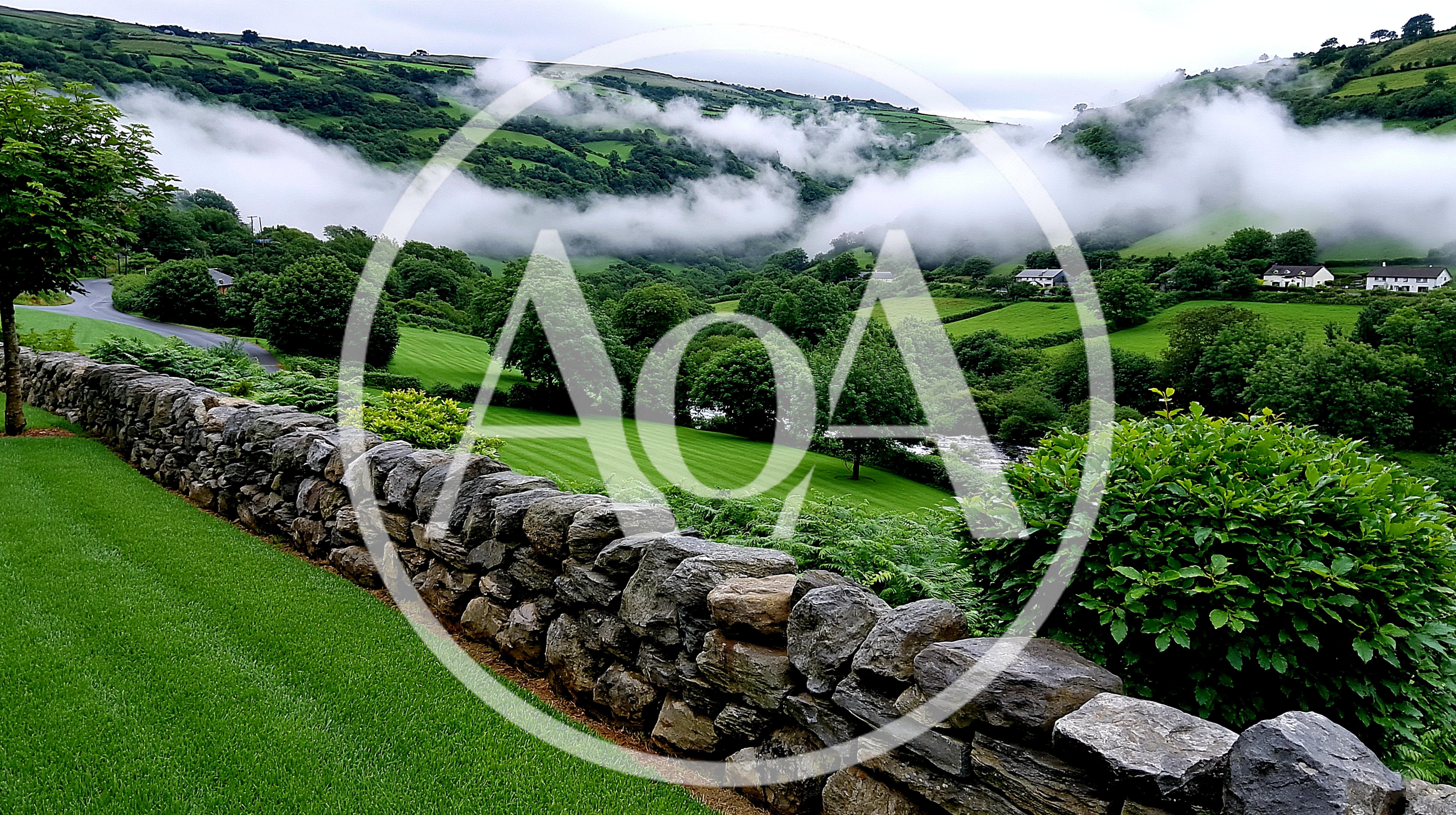 Lush Green Valley Landscape With Rolling Hills And Mist