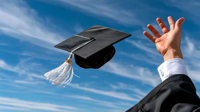 Graduation Cap Tossed Into The Blue Sky