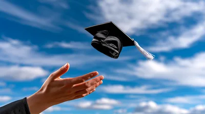 Graduation Cap Tossed Into The Blue Sky