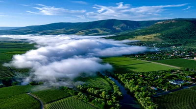 Aerial View Of Low Clouds Over A Lush Valley