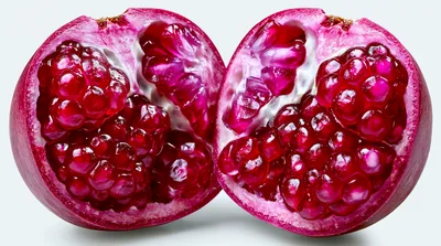 Two Halves Of A Fresh Ripe Pomegranate
