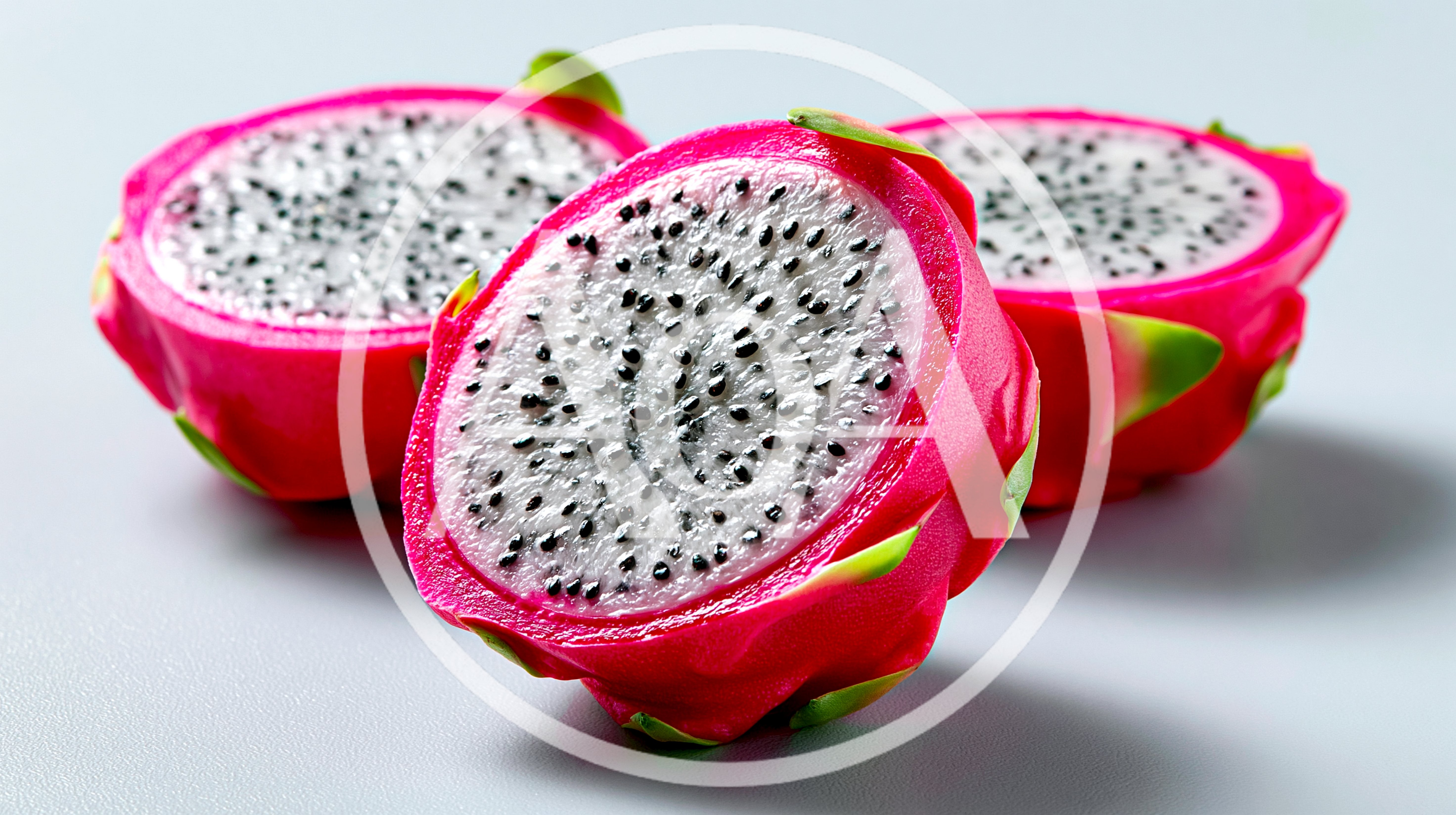 Three Halved Dragon Fruits On A White Background
