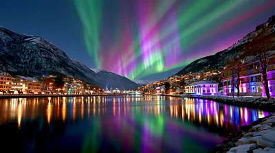 Vibrant Aurora Borealis Over A Snowy Norwegian Town