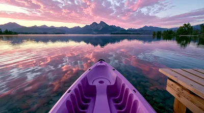 Purple Kayak Floating On A Calm Mountain Lake