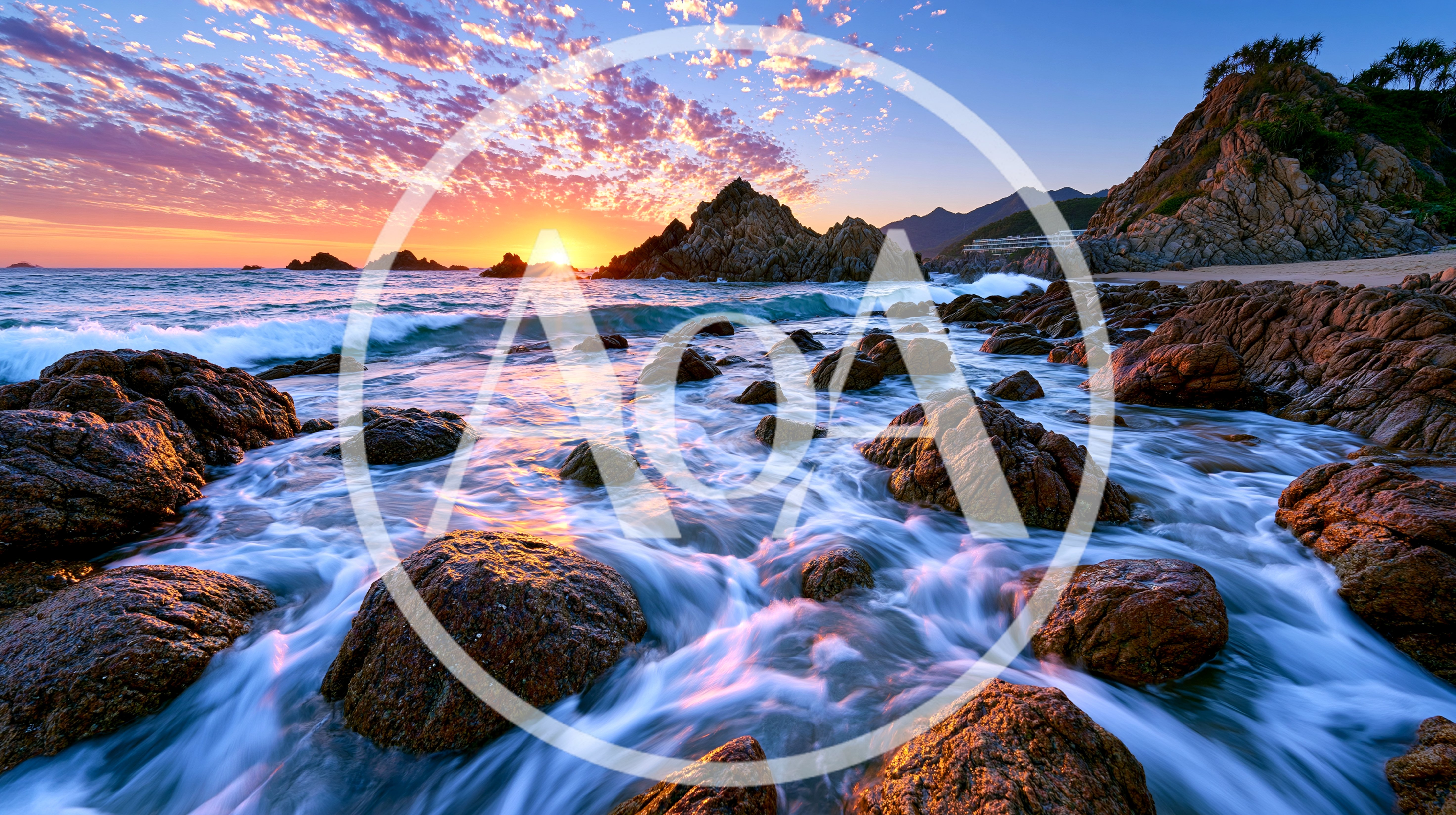 Rocky Coastline At Sunset With Crashing Waves