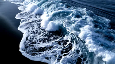 Aerial View Of Crashing Ocean Wave On Dark Sand