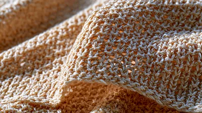 Close Up Of Beige Knitted Fabric Texture