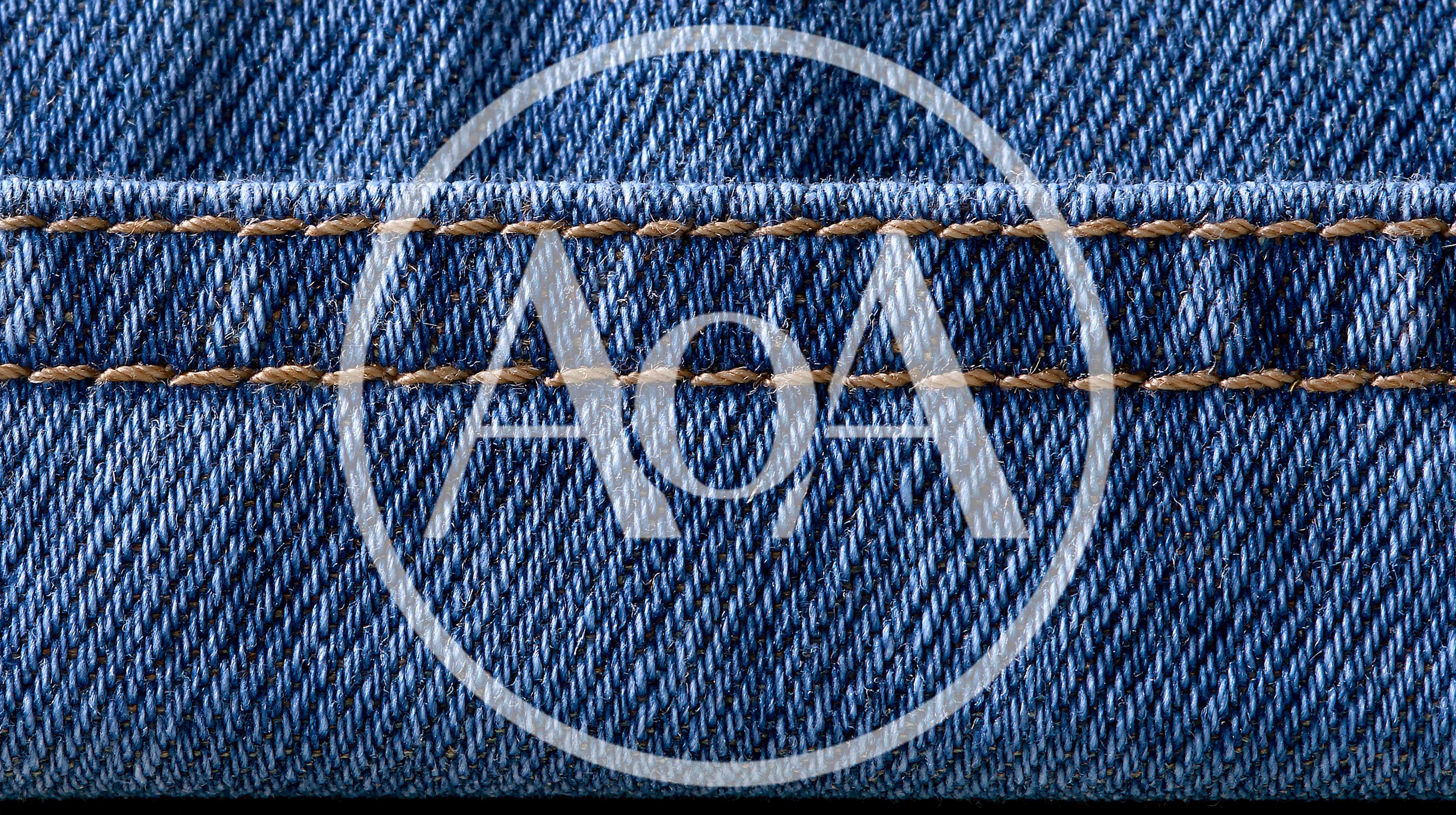 Close Up Of Blue Denim Fabric With Stitching