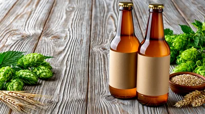 Two Amber Beer Bottles With Hops And Barley
