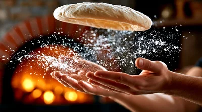 Chef Tossing Pizza Dough In Front Of Wood Oven