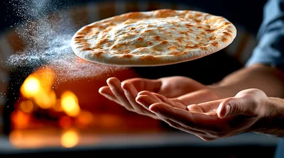 Chef Tossing Pizza Dough In Front Of Wood Oven