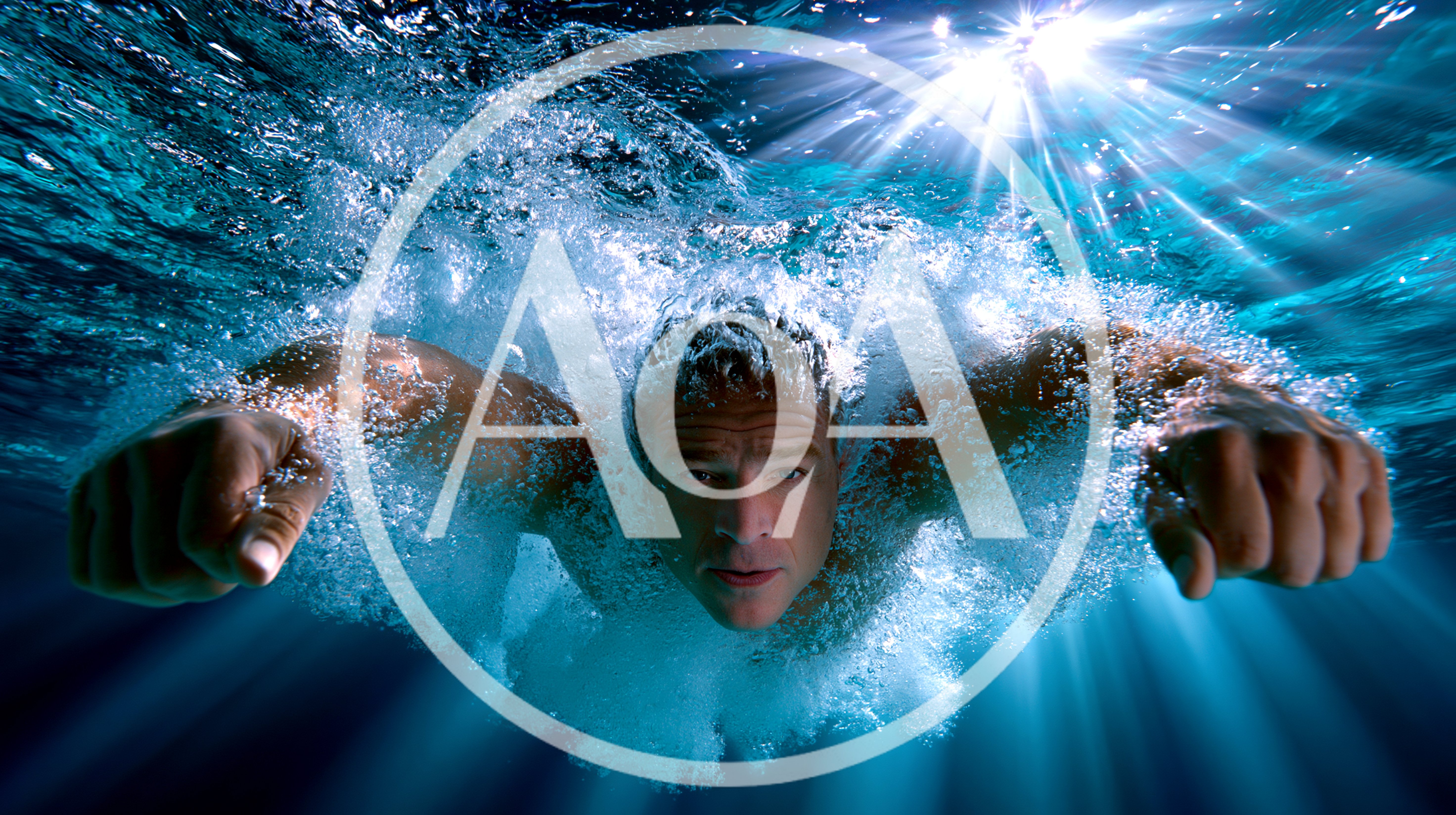 Man Swimming Underwater With Bubbles And Sun Rays