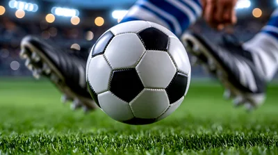 Soccer Player Kicking Ball On Professional Grass Field
