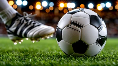 Soccer Player Kicking Ball On Professional Grass Field