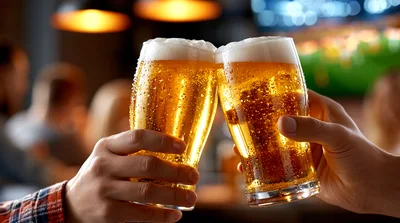 Two People Toasting With Glasses Of Cold Beer