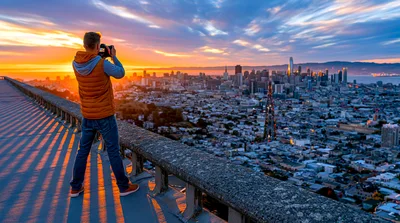Photographer Capturing Sunset Over San Francisco Skyline