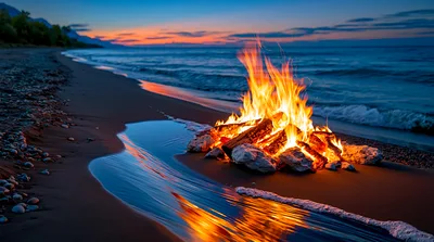 Bonfire Burning on a Rocky Beach at Sunset