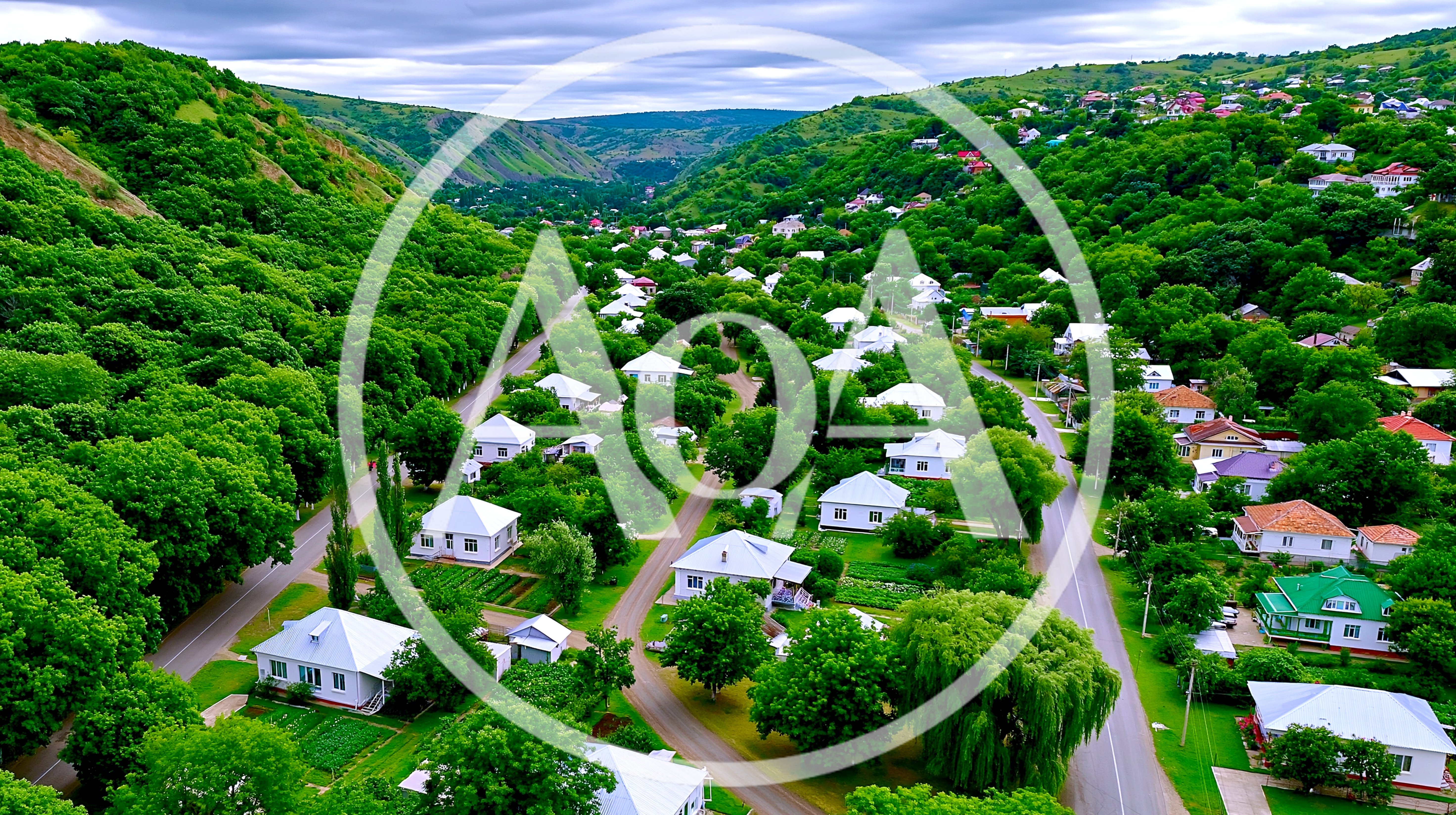Aerial View Of A Village Nestled In A Green Valley