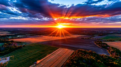 Aerial View Of Combine Harvester In Wheat Field At Sunset